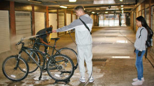 Young man cleaning a bicycle