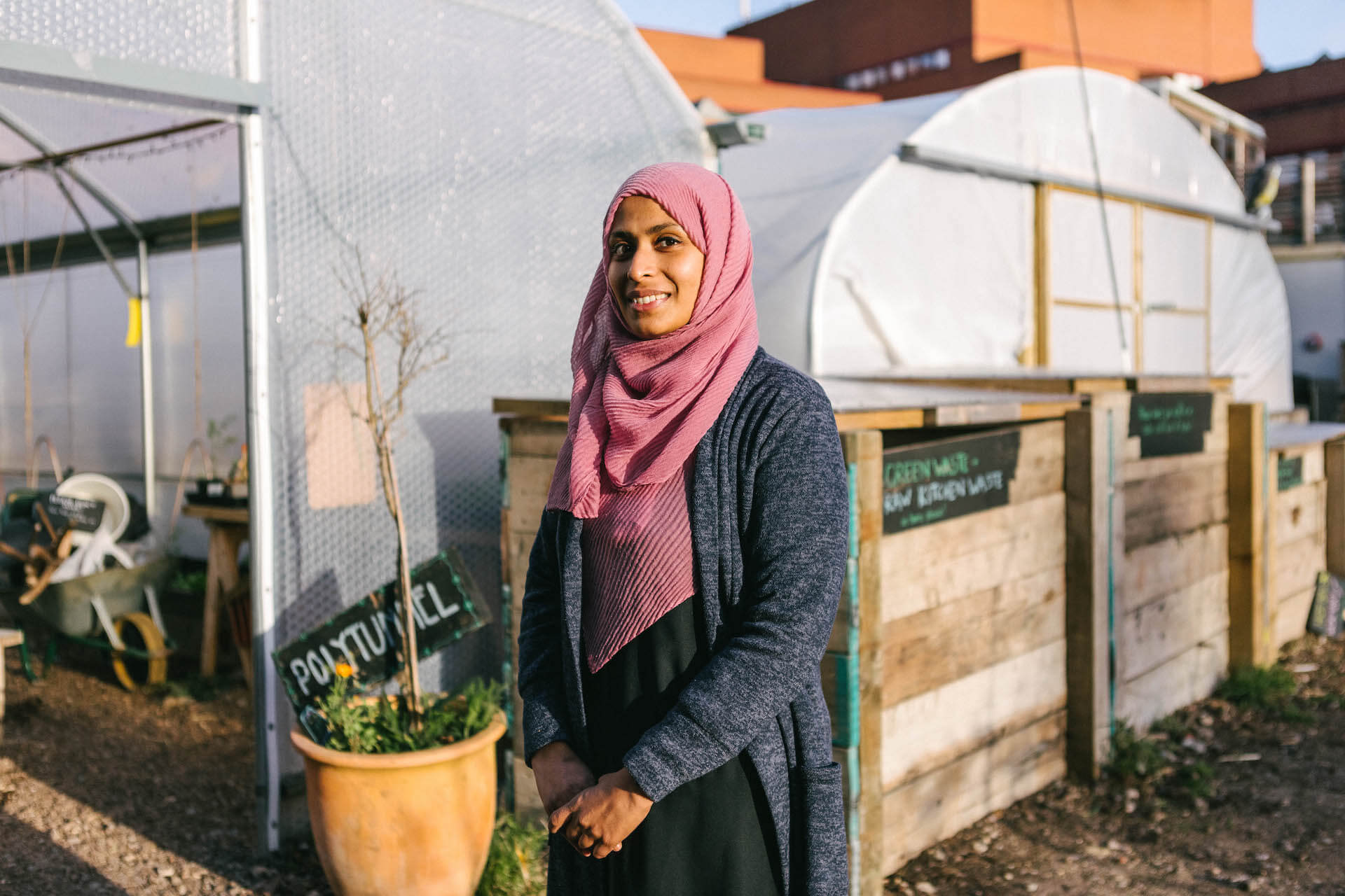 Salina Khatun, the founder of Read and Play, standing by some polytunnels