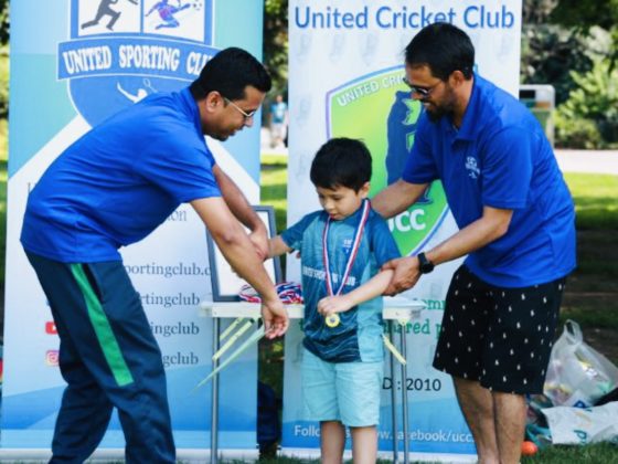 Boy receiving medal at United cricket club