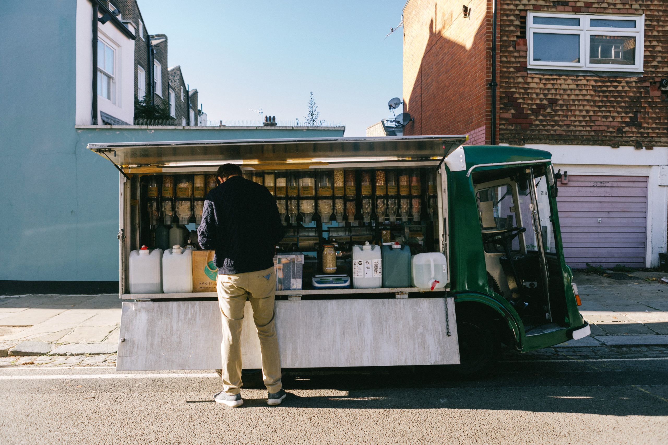 Food van with someone standing in front of it looking at the produce