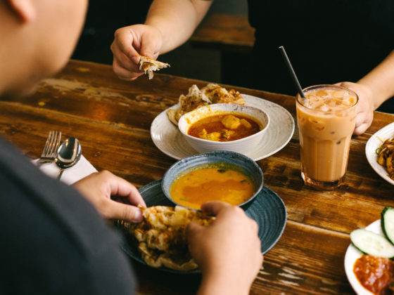 People eating roti and curry