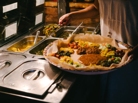 Person dishing food onto a plate