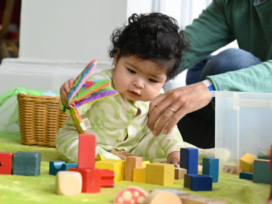 Baby playing with colourful wooden blocks