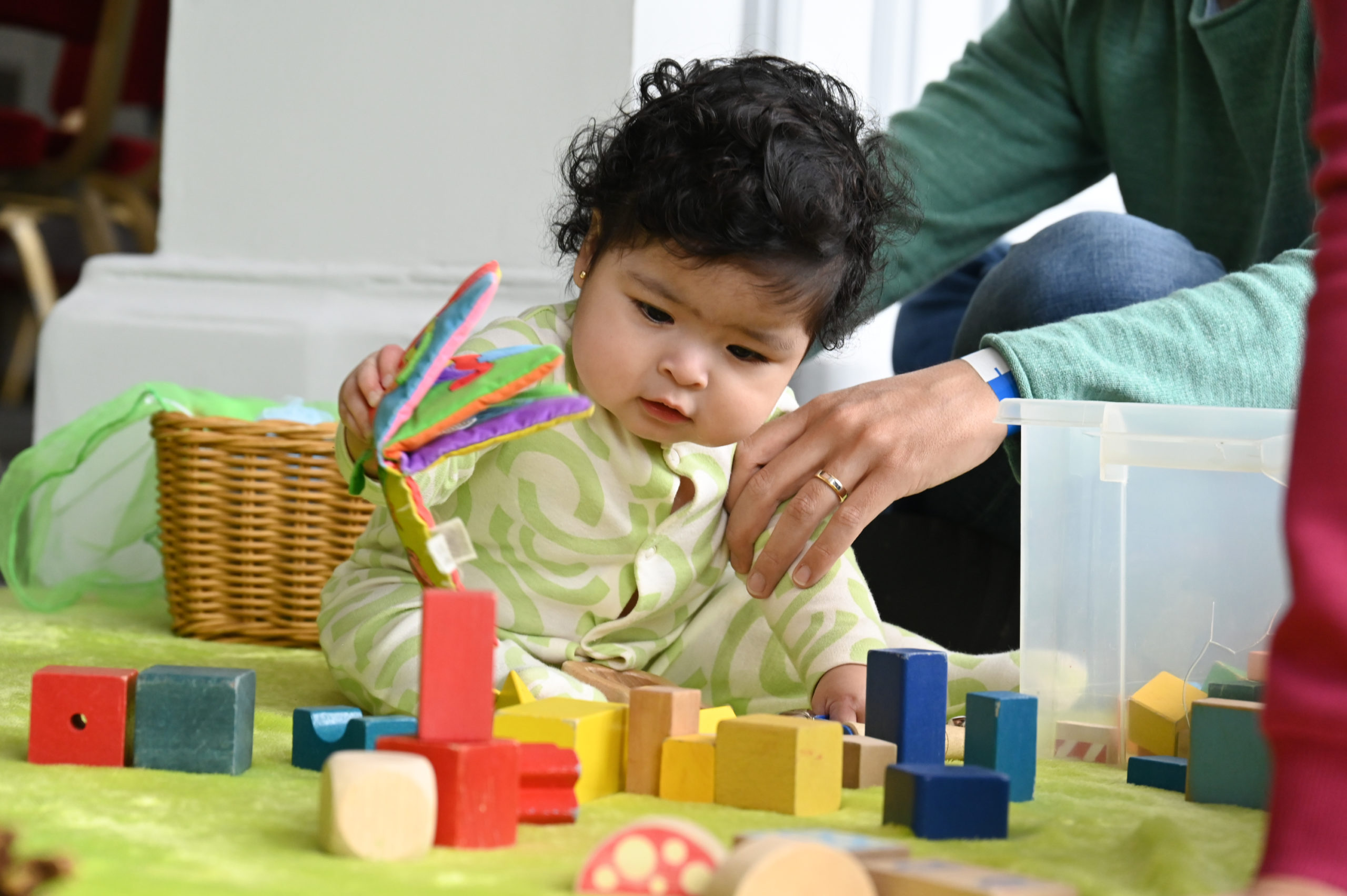 Baby playing with colourful wooden blocks