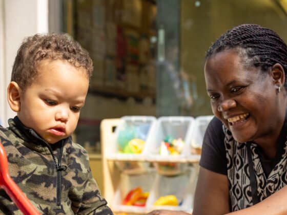 Woman and toddler playing with sand