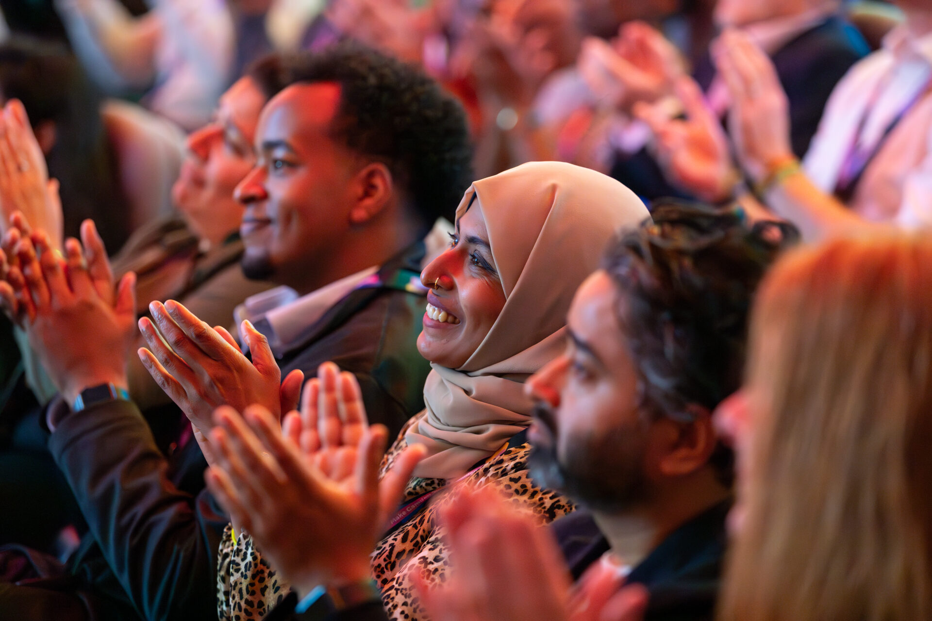 Members of the audience clap the presenters while sat down.