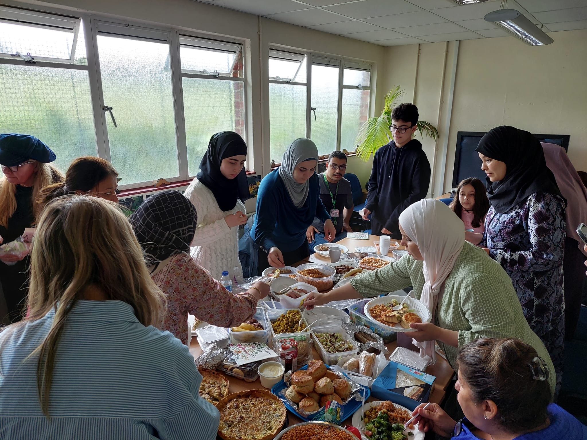 Lamigaa’s volunteer mentors and mentees come together for a buffet as a group.