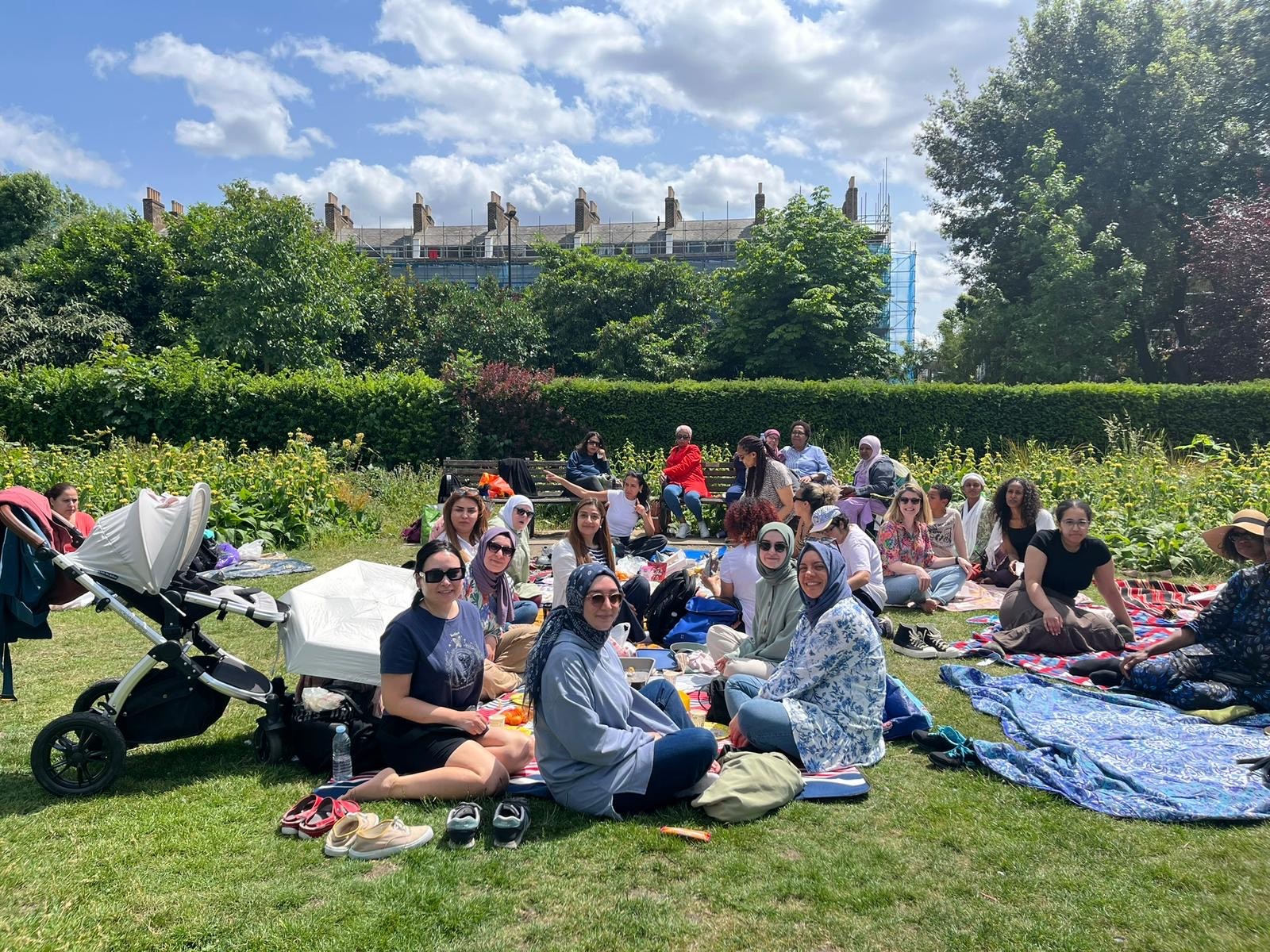Lamigaa’s volunteer mentors and mentees come together for a summer picnic, they are photographed as a group.