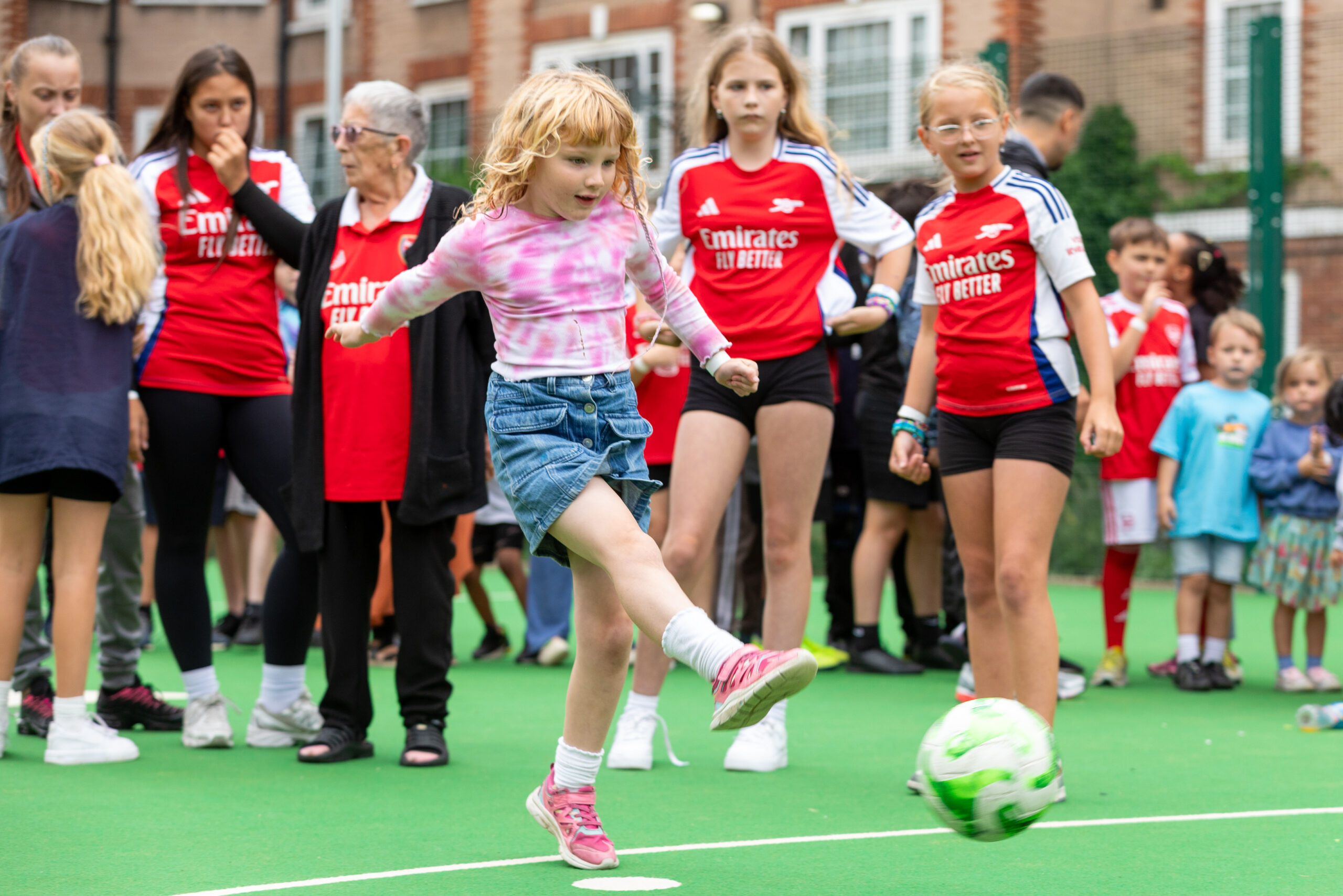 Children playing football in arsenal kit